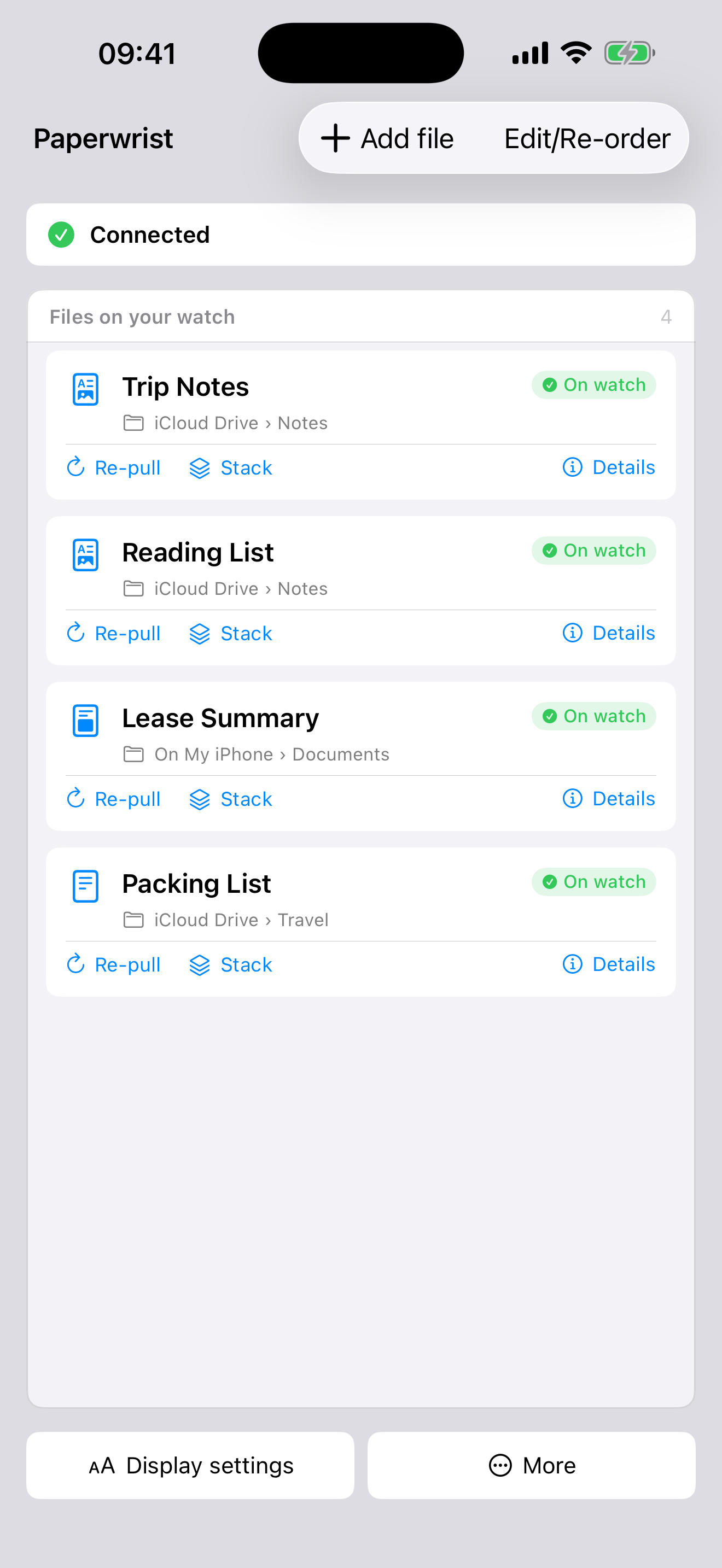 Paperwrist on iPhone: a 'Connected' banner above a card for each file on the watch — Trip Notes, Reading List, Lease Summary and Packing List — each marked 'On watch' with Re-pull, Stack and Details actions, and Display settings and More pinned at the bottom.